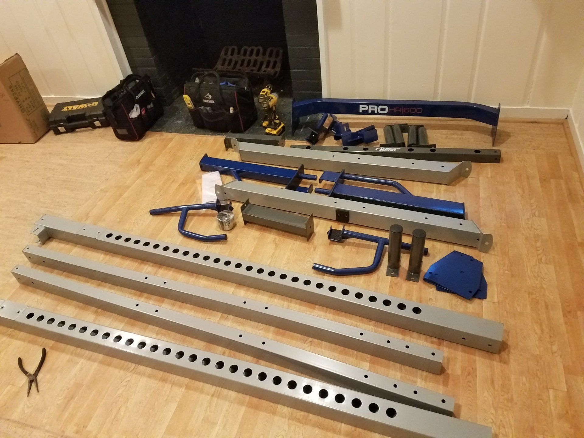 A bunch of metal pieces are laying on the floor in a room.