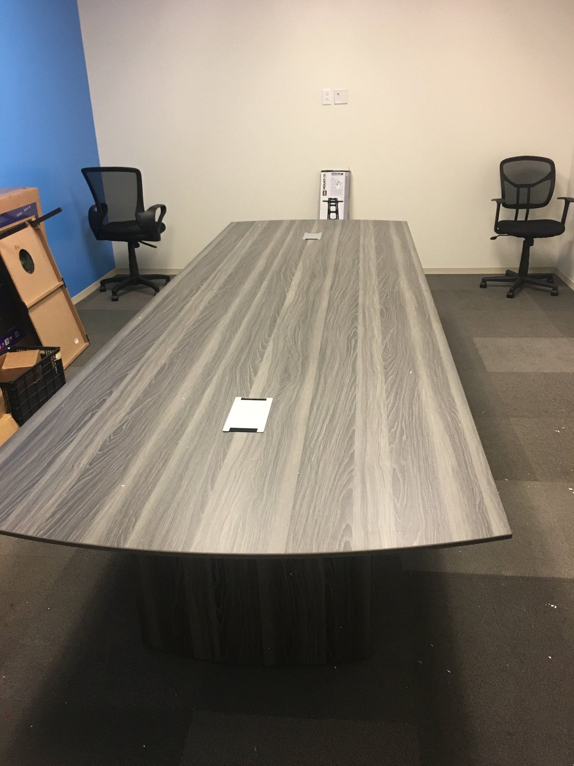 A conference room with a long table and chairs