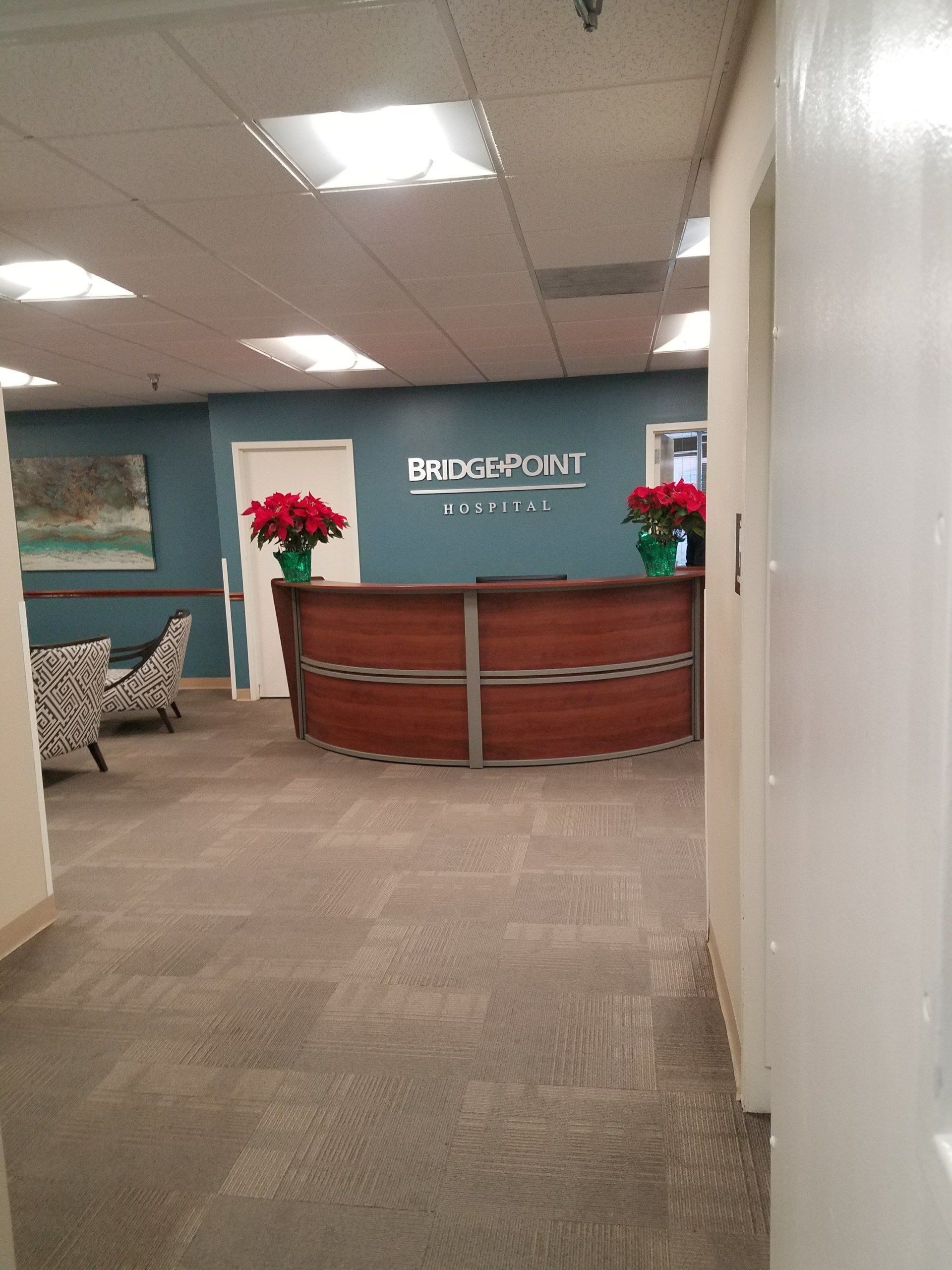 A lobby with a wooden desk and a sign that says bridgeport