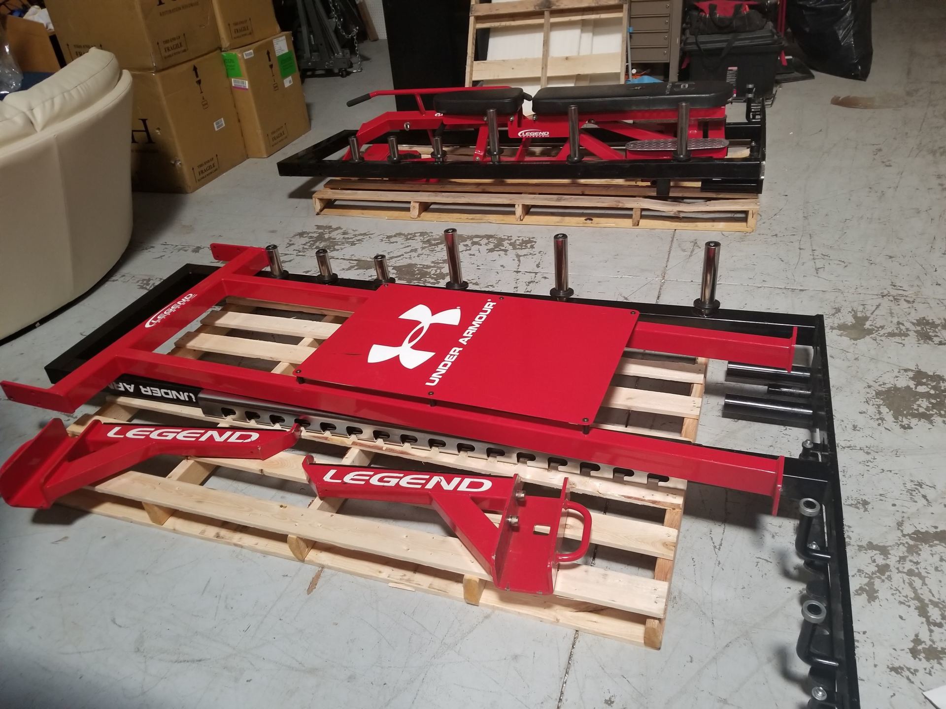 A red under armour item is sitting on a wooden pallet