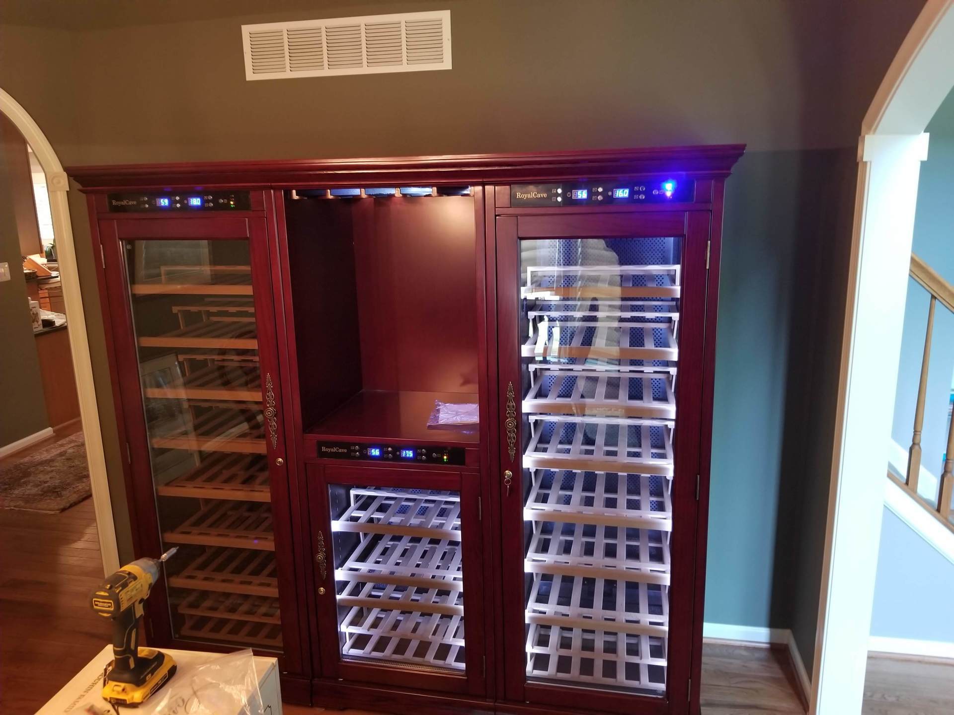 There is a wine cooler in the middle of the room.