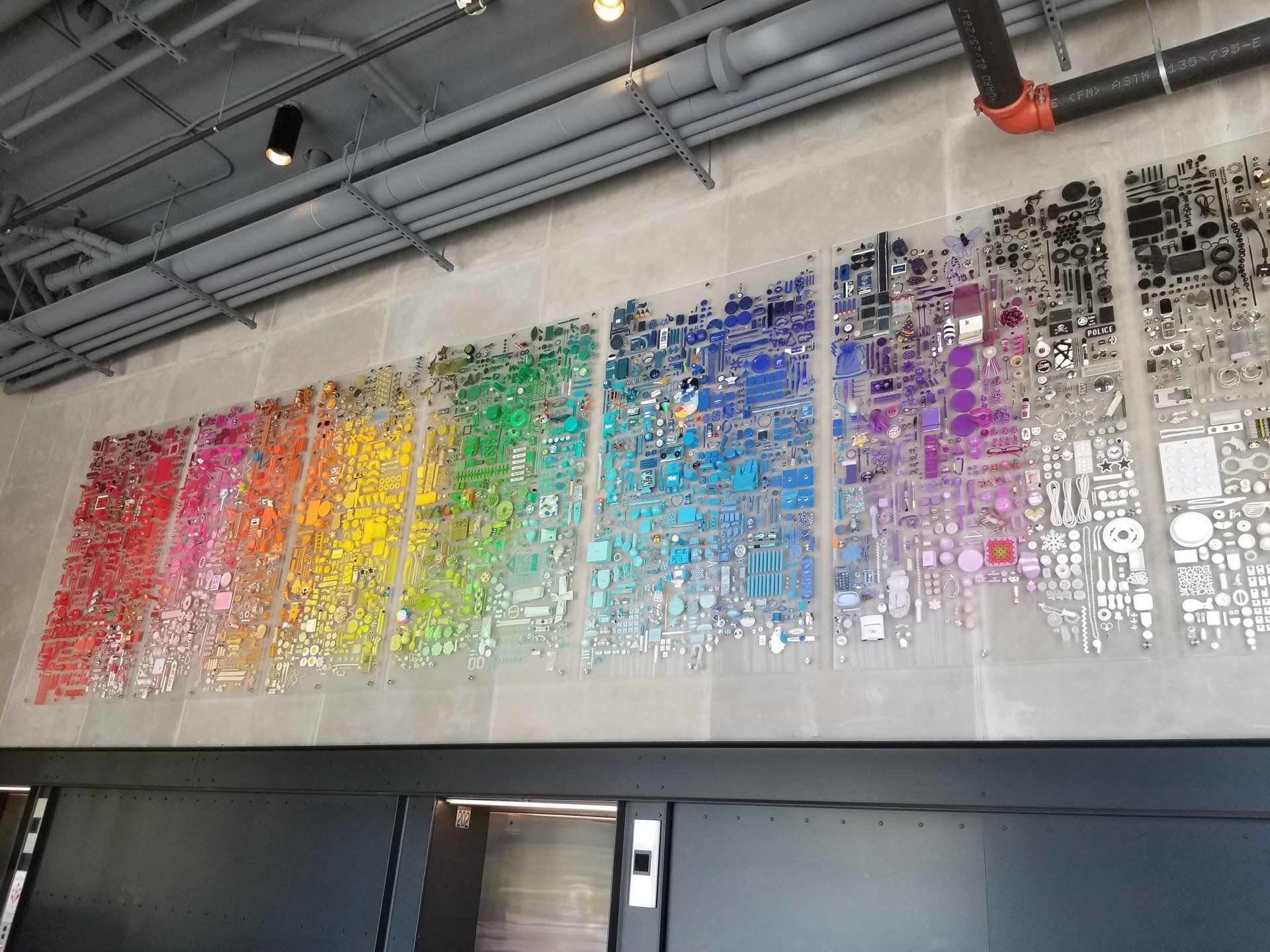A wall with a rainbow of colors on it