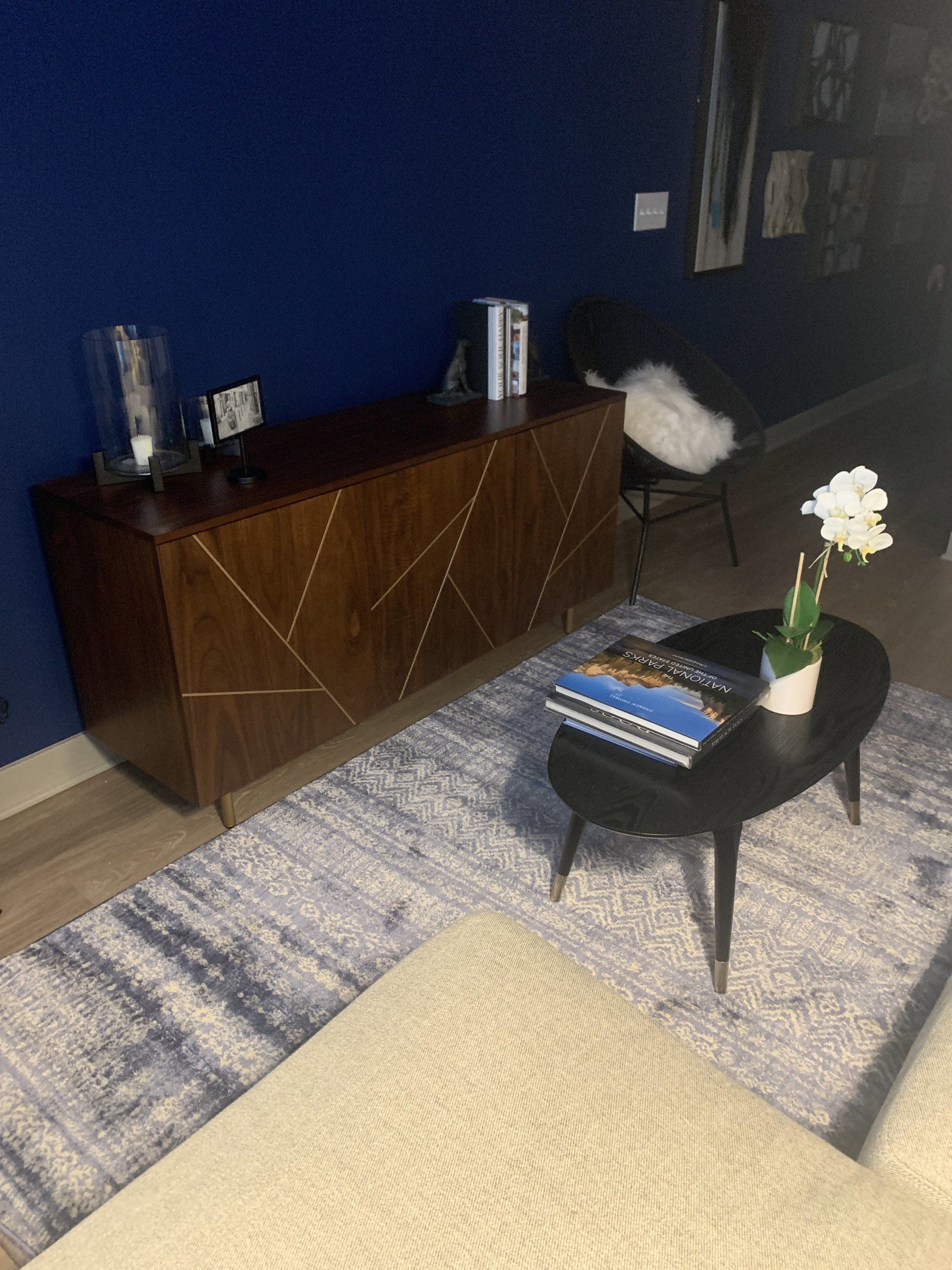 A living room with a coffee table and a dresser