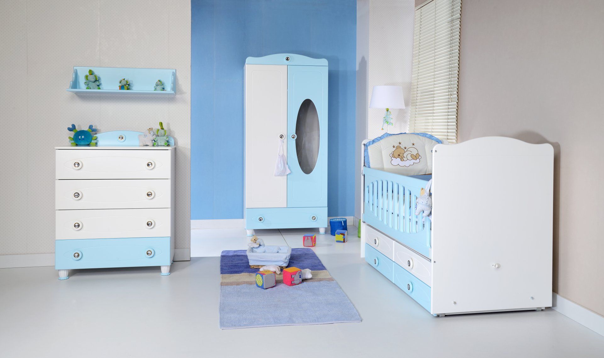 A baby room with a crib , dresser , and wardrobe.