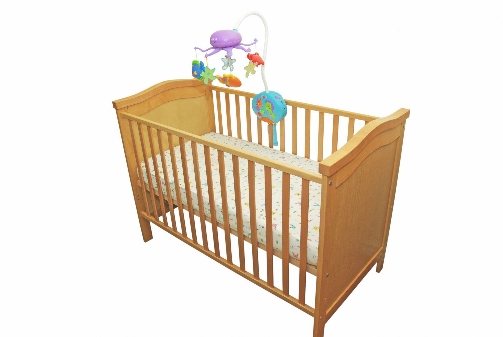 A wooden crib with a mobile attached to it