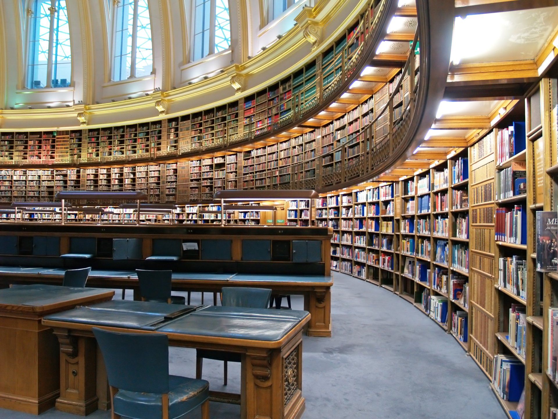 A library with a curved ceiling and lots of books on shelves