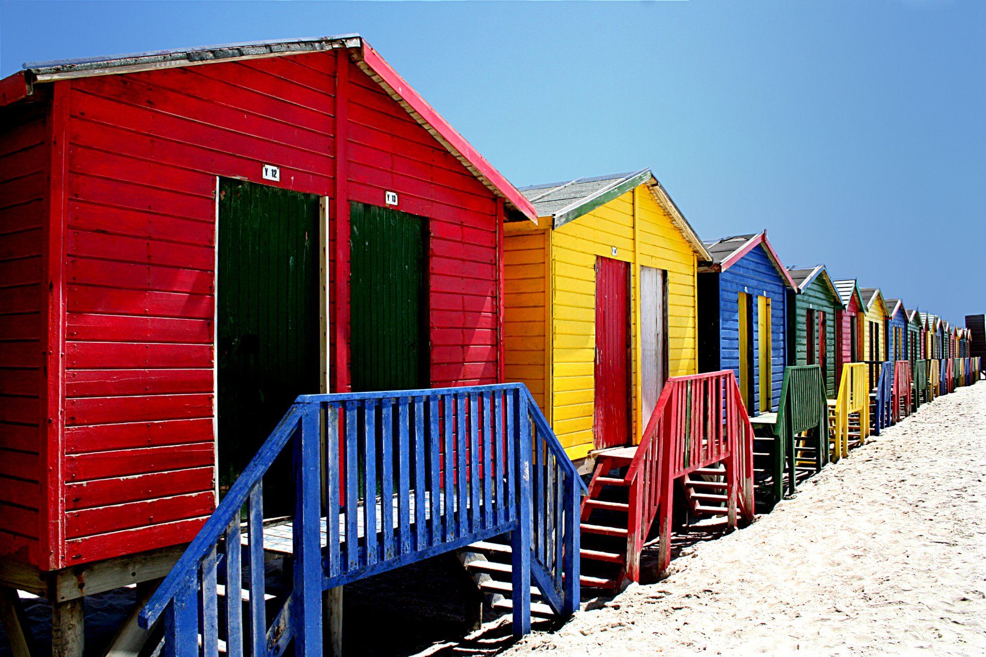 A row of colorful beach huts on a beach