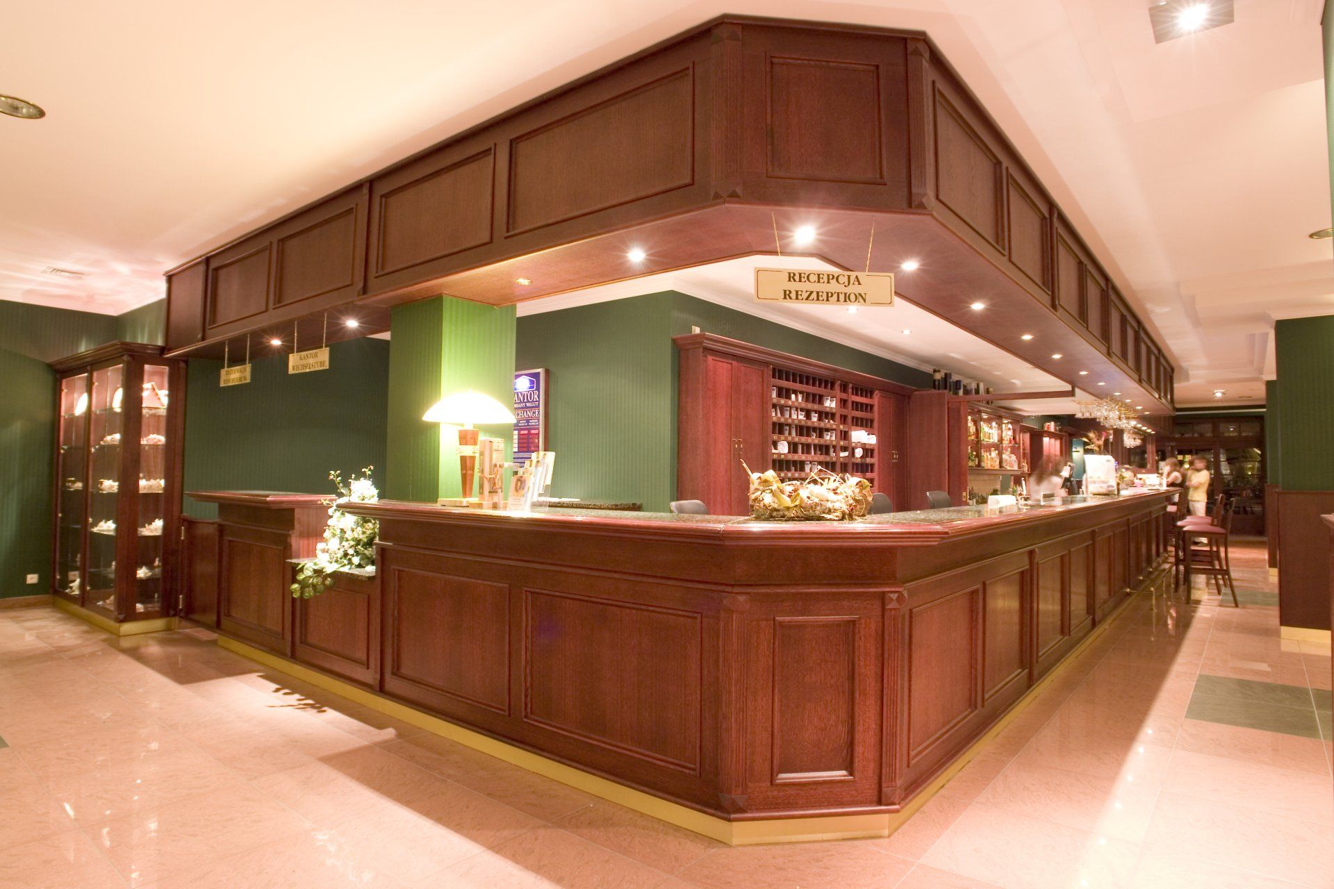 A hotel lobby with a large wooden counter