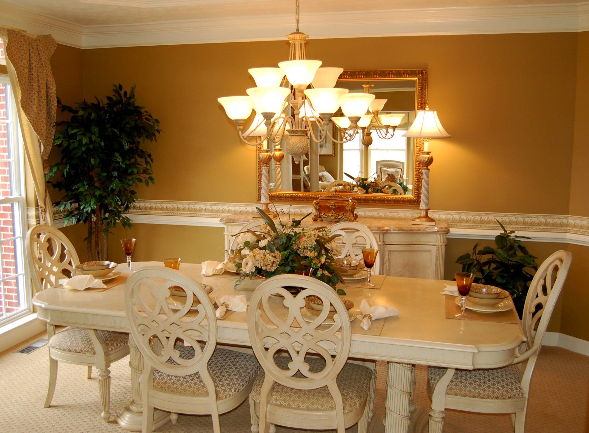 A dining room with a table and chairs and a chandelier
