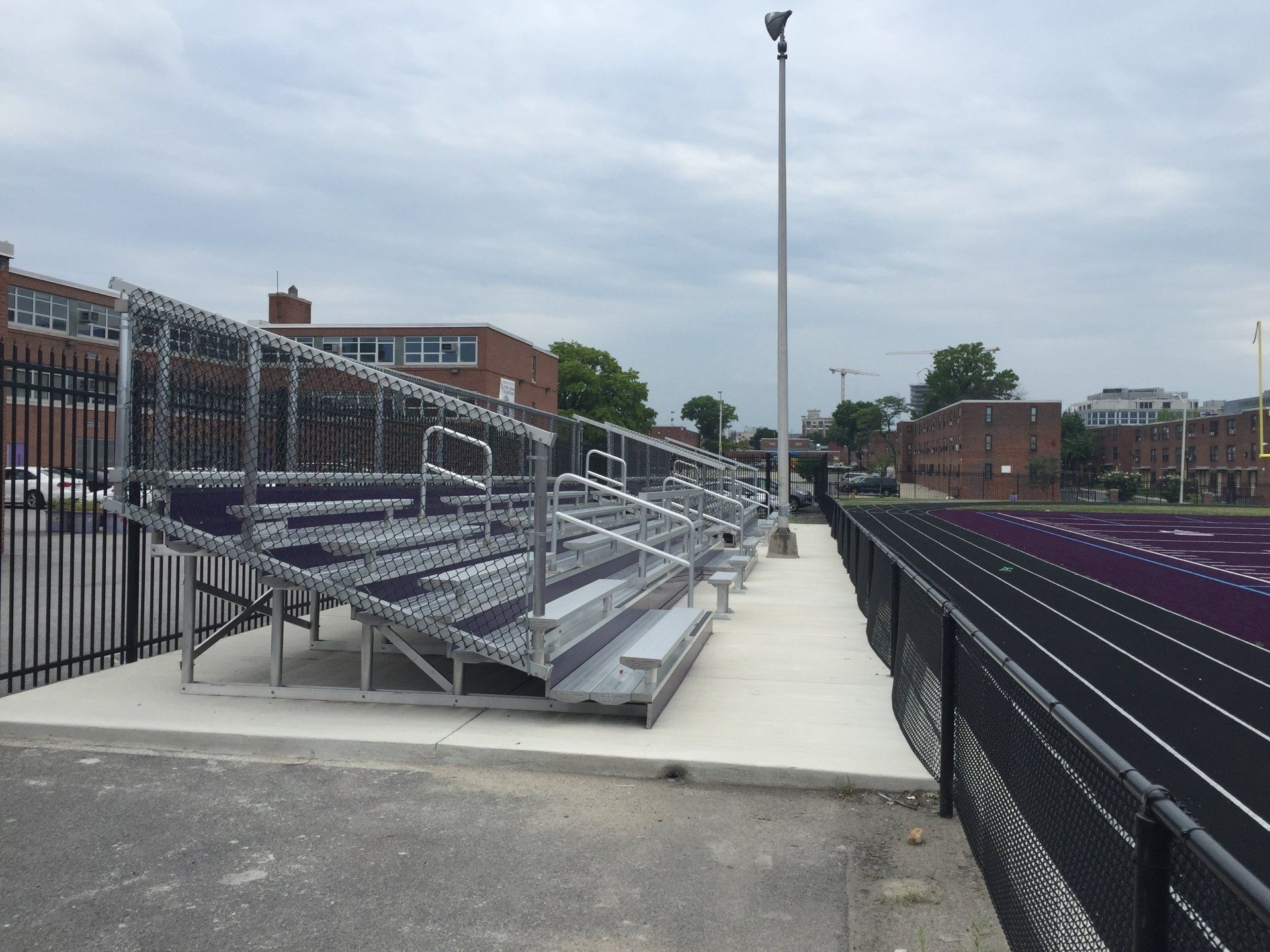 A stadium with bleachers and a fence around it