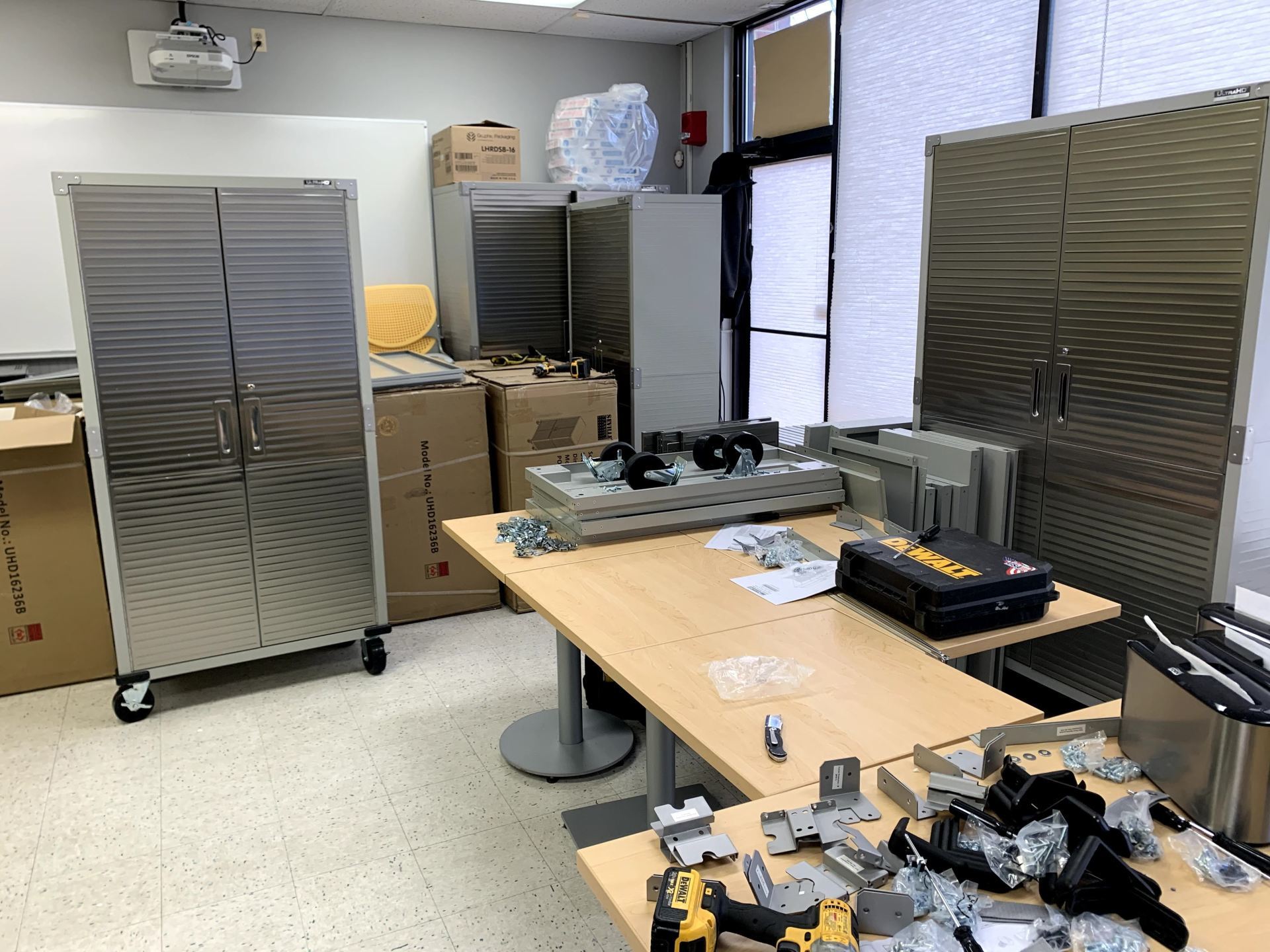 A room with a lot of boxes on the floor and a table with tools on it.