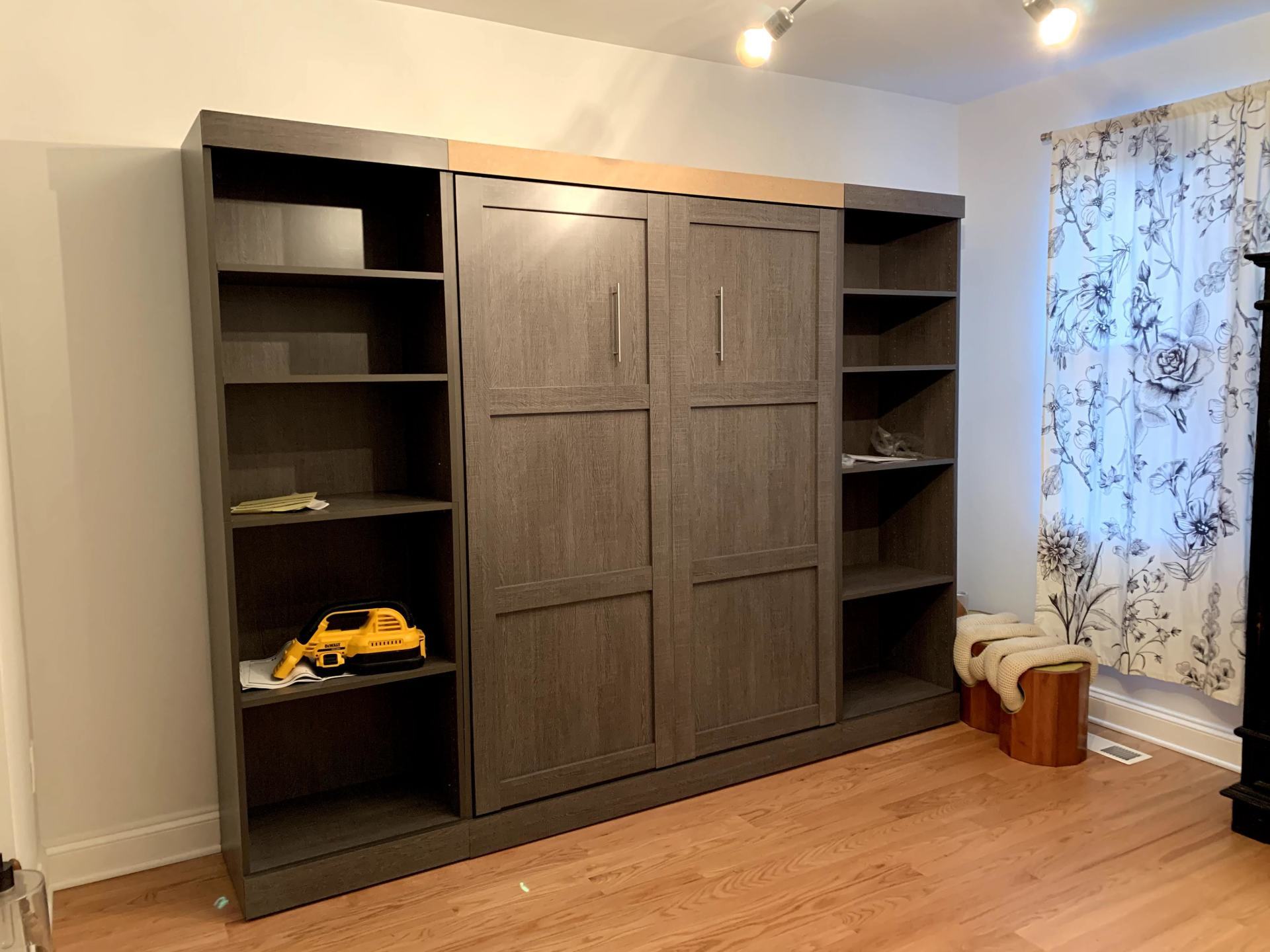 There is a toy truck on the shelf in the middle of the room.