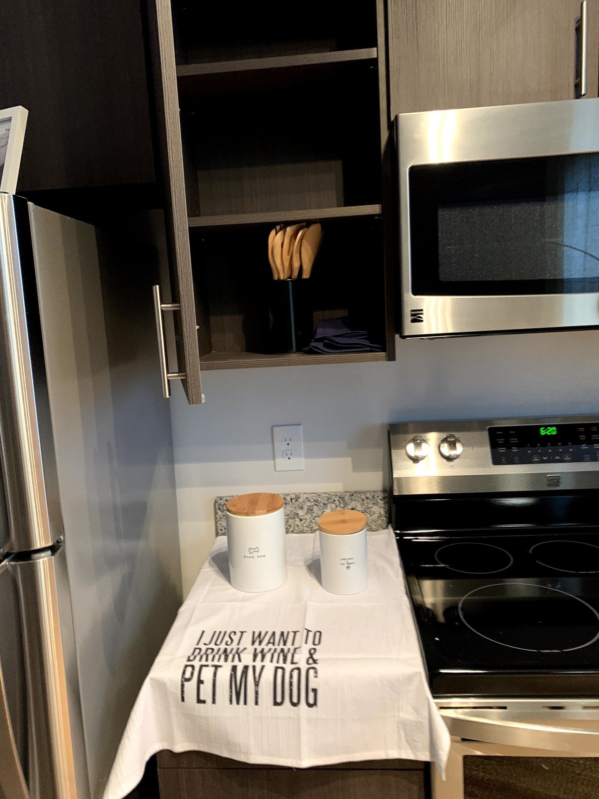 A kitchen with a towel that says i just want to drink wine and pet my dog