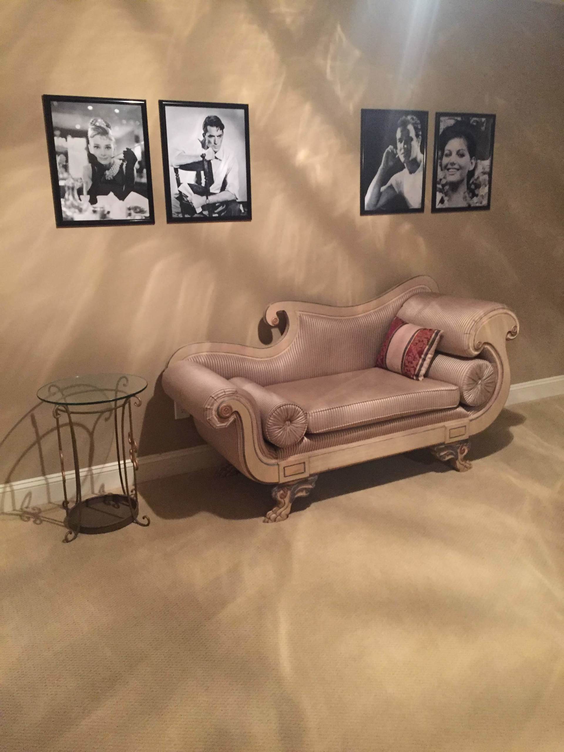 A living room with a couch and pictures on the wall