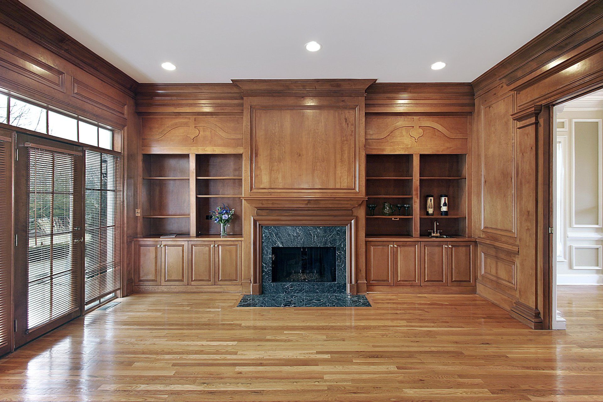 A living room with hardwood floors and a fireplace