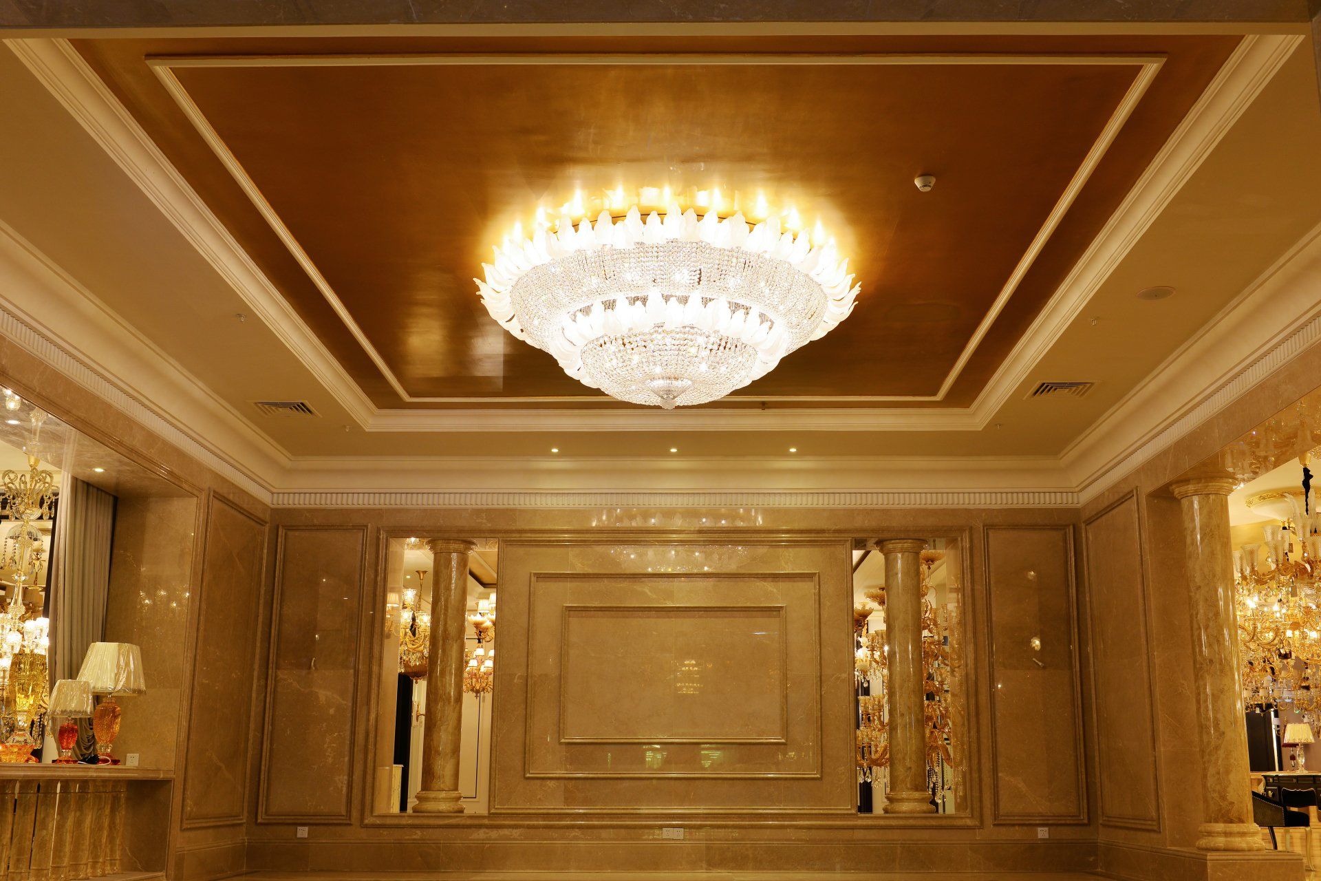 A large chandelier is hanging from the ceiling of a large room.