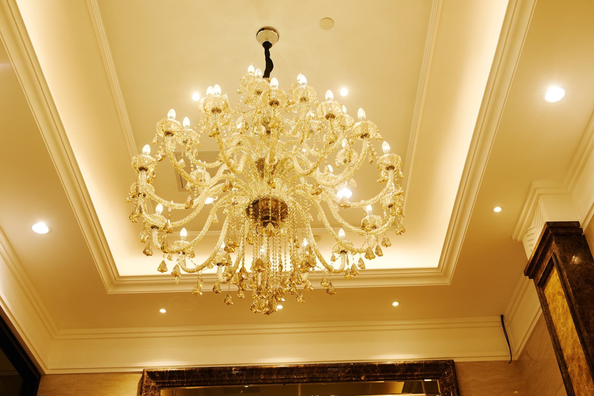 A large chandelier is hanging from the ceiling of a room.