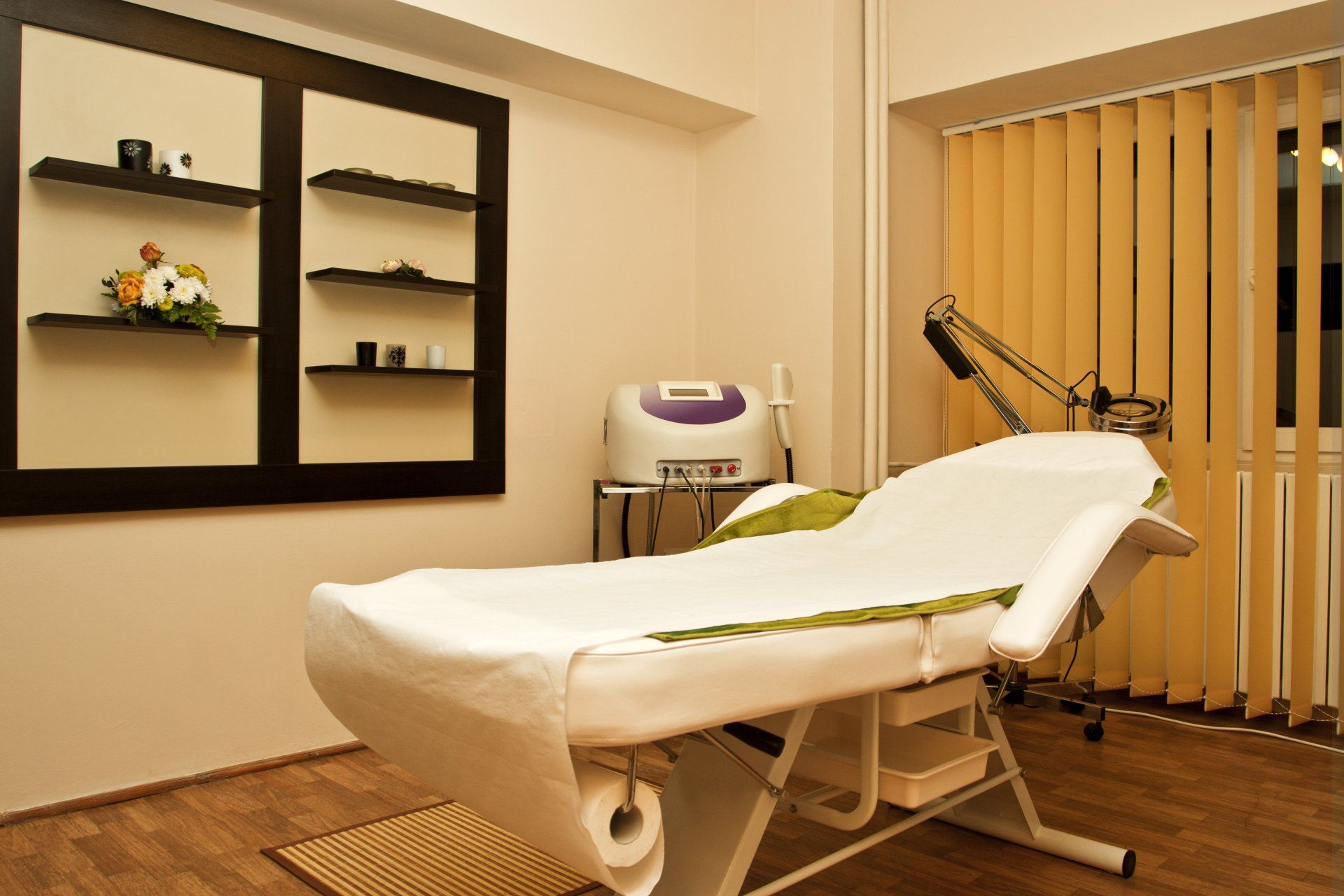 A white bed in a room with a purple machine