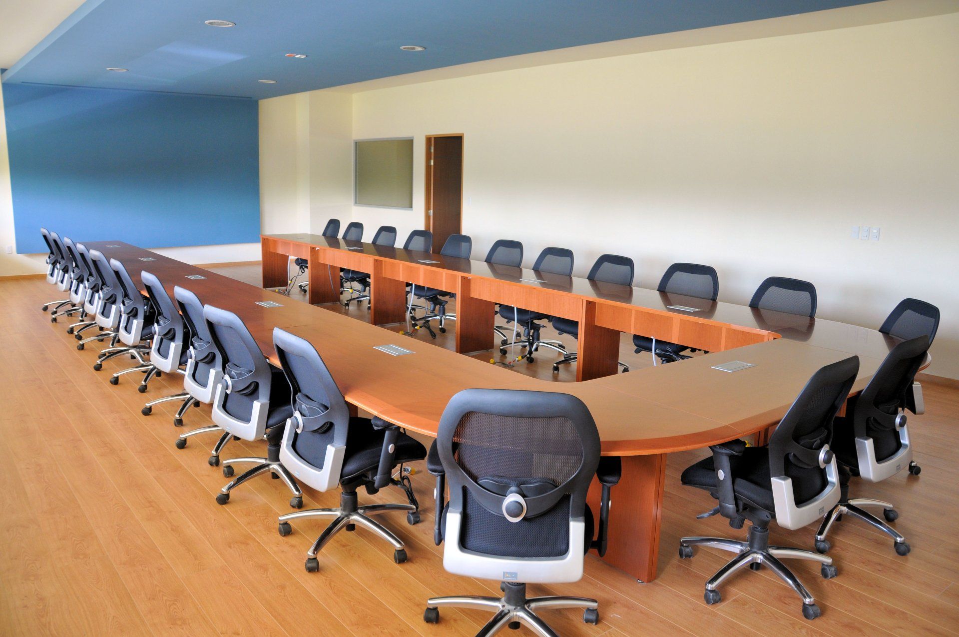 A conference room with a long table and chairs