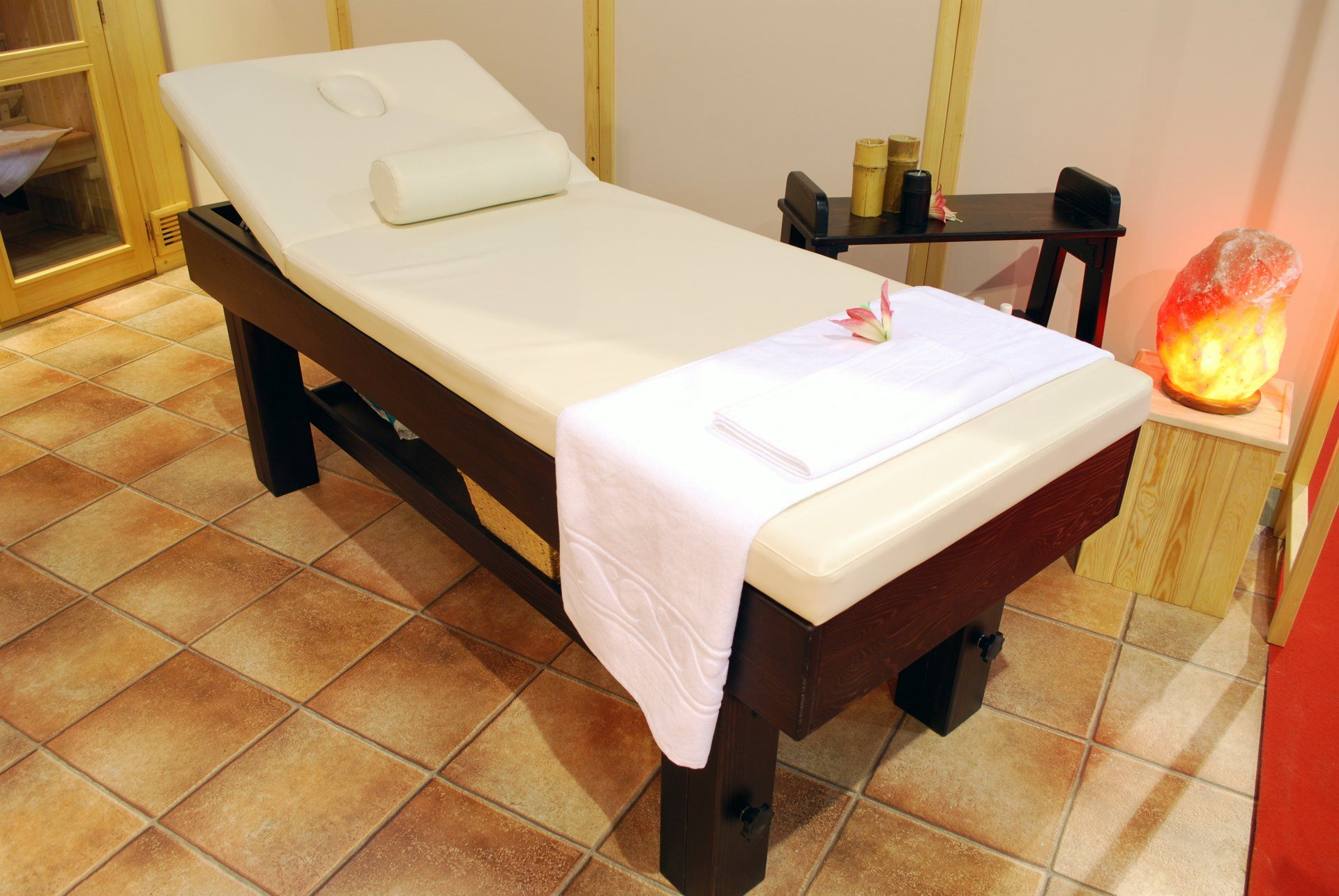 A massage table with a white towel on it
