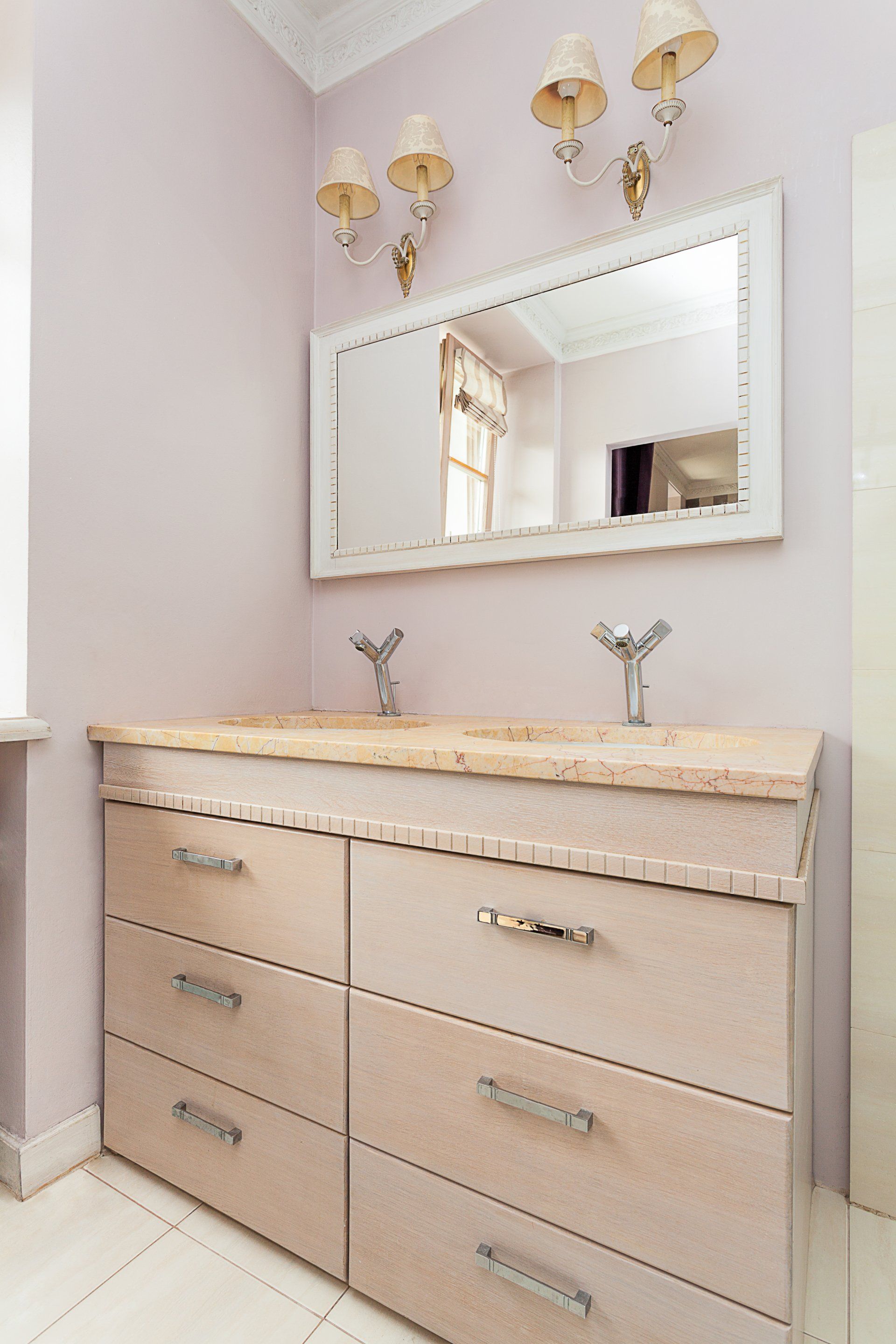 A bathroom with two sinks and a large mirror.