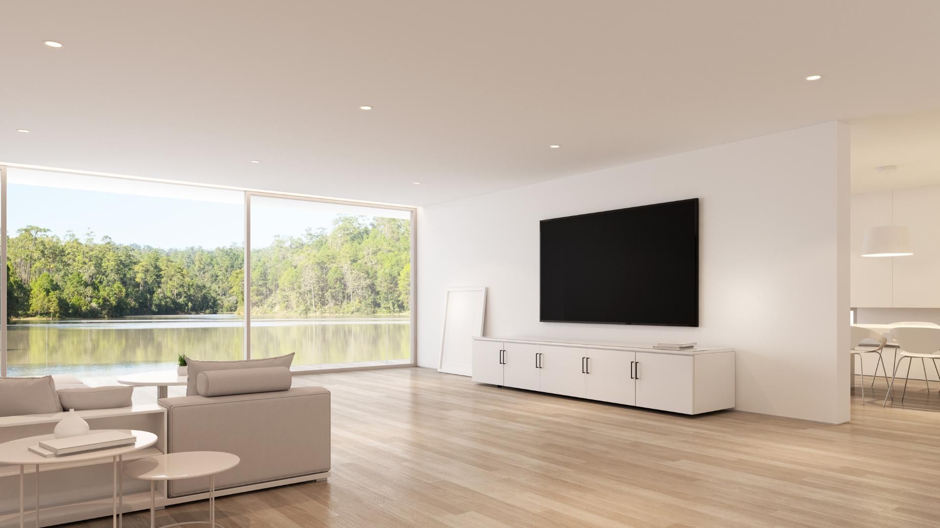 A living room with a large flat screen tv on the wall.