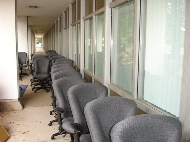 A long hallway with rows of chairs and windows