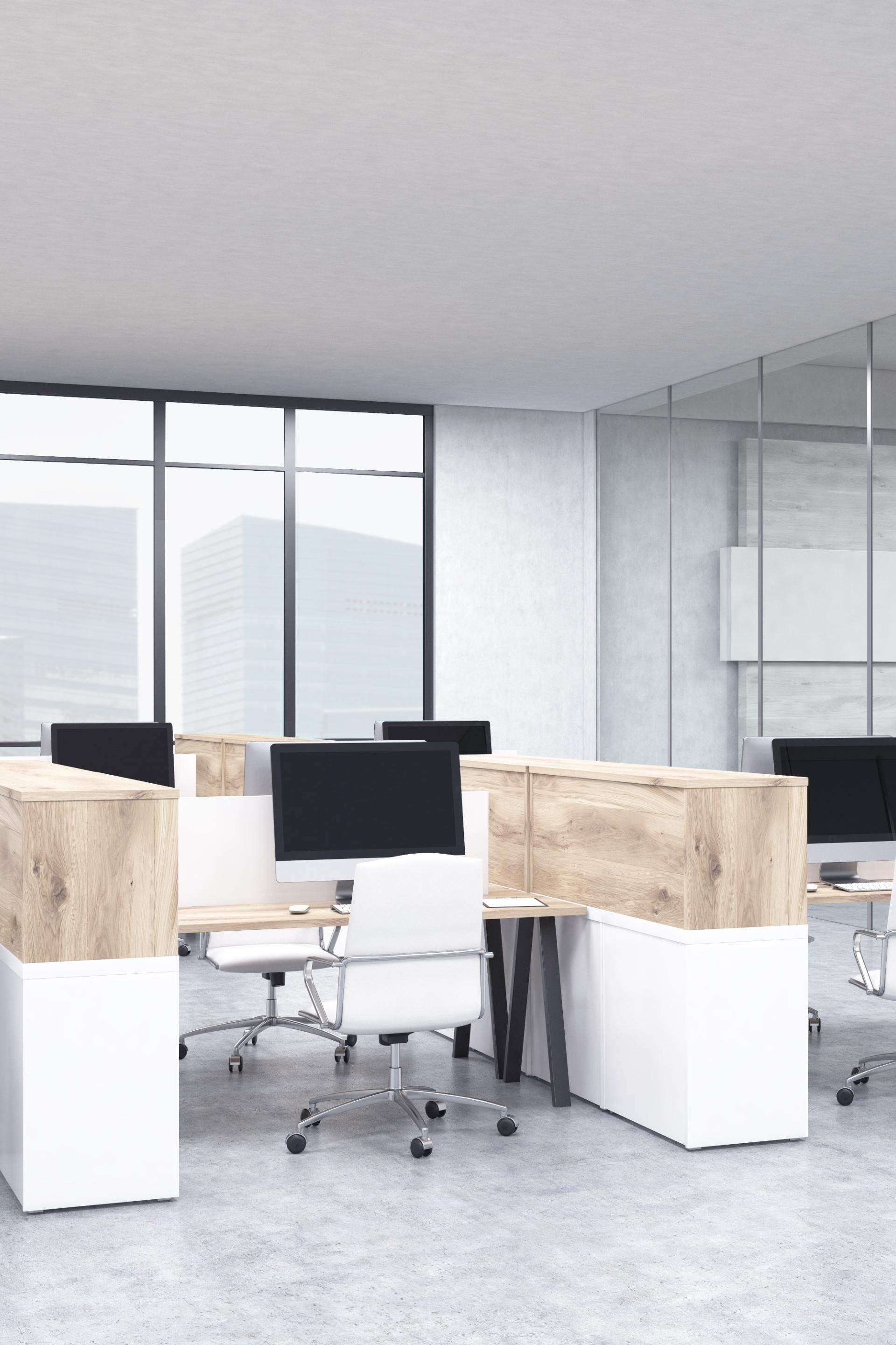 A modern office with a lot of windows and cubicles