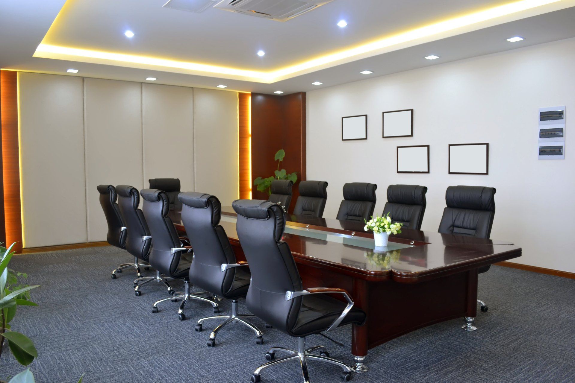 A conference room with a long table and chairs.