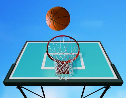 A basketball is going through a hoop on a basketball court.