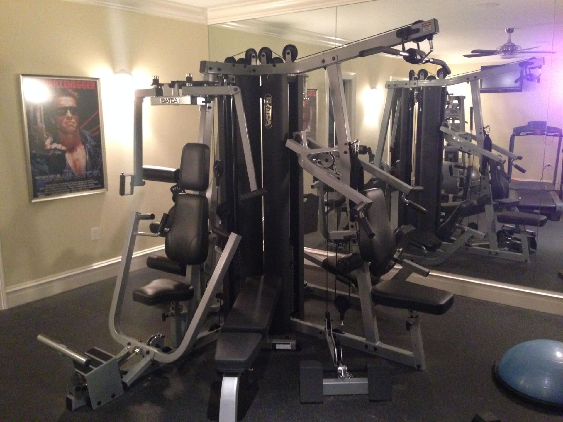 A gym with a poster on the wall that says rambo