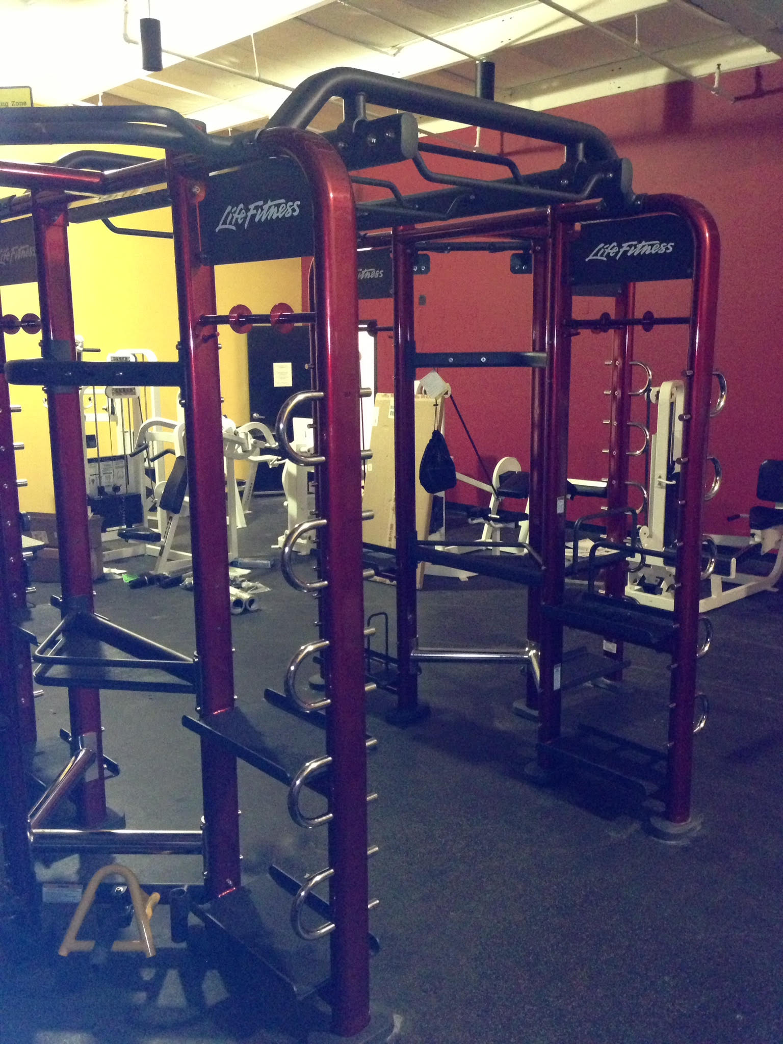 A gym with a lot of exercise equipment and a sign that says 24