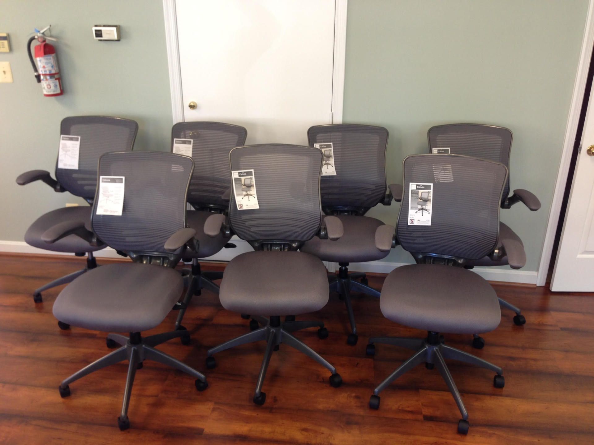 A bunch of office chairs are lined up in a room
