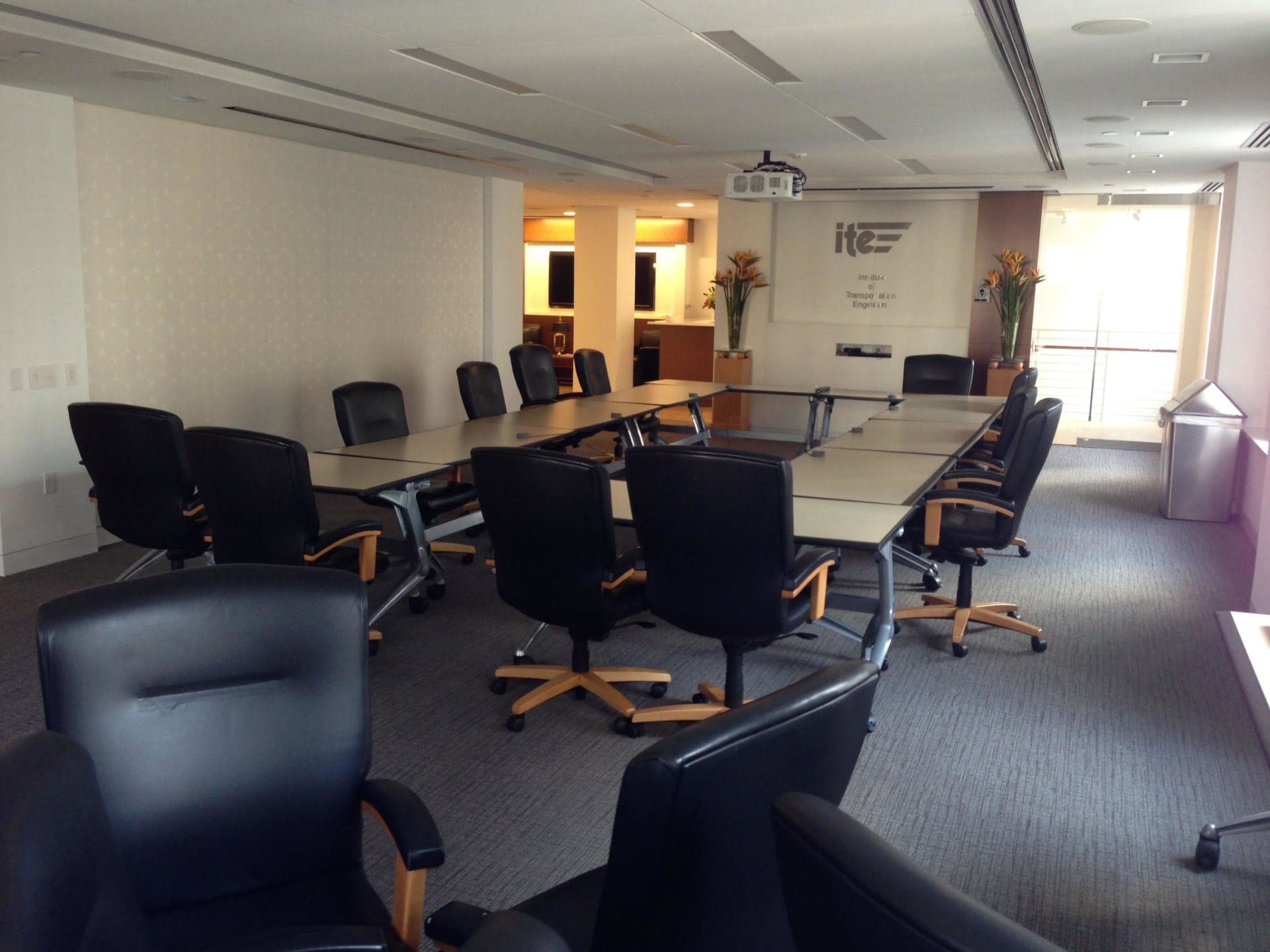 A conference room with a long table and chairs