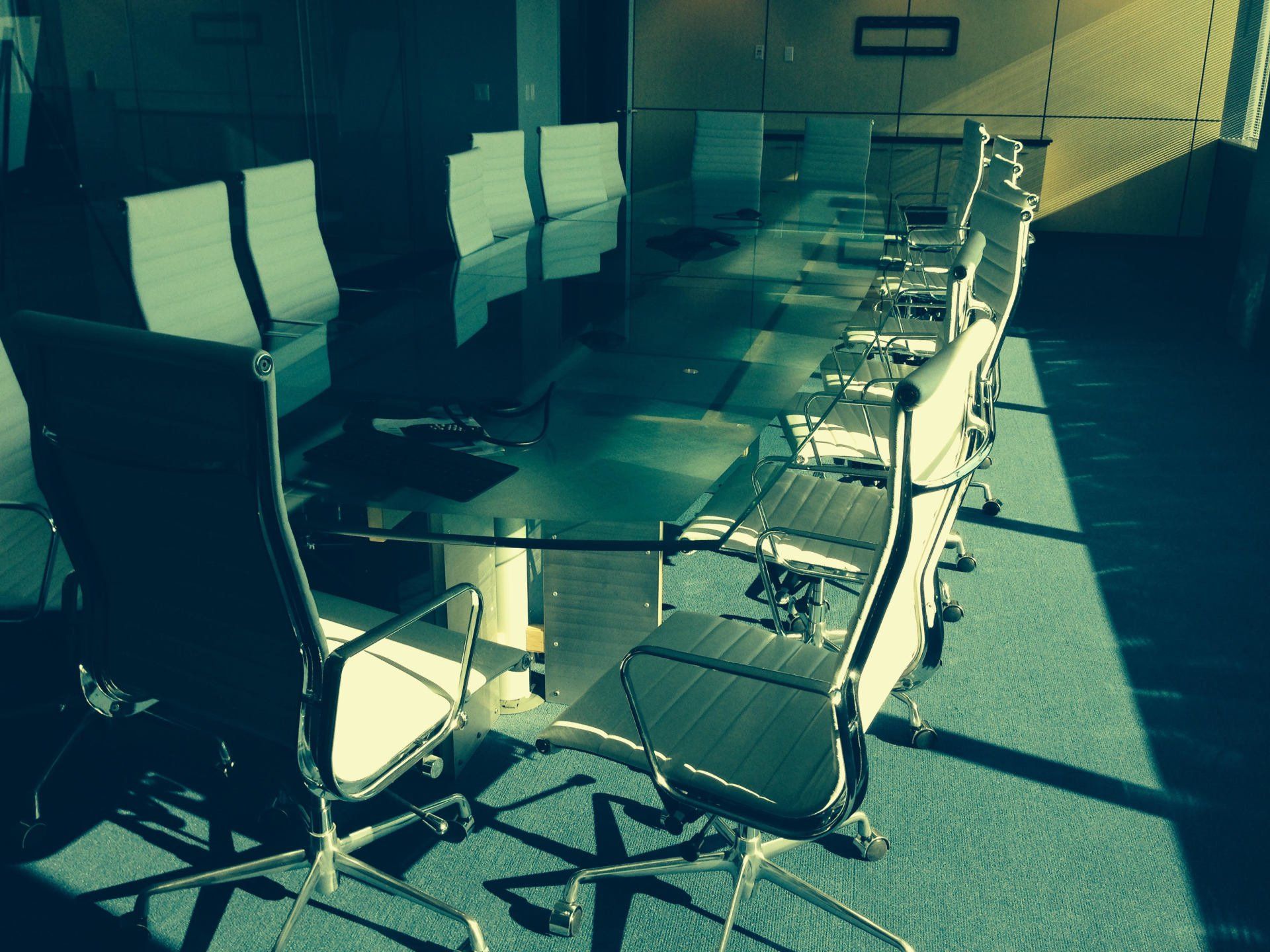 A conference room with a long table and chairs