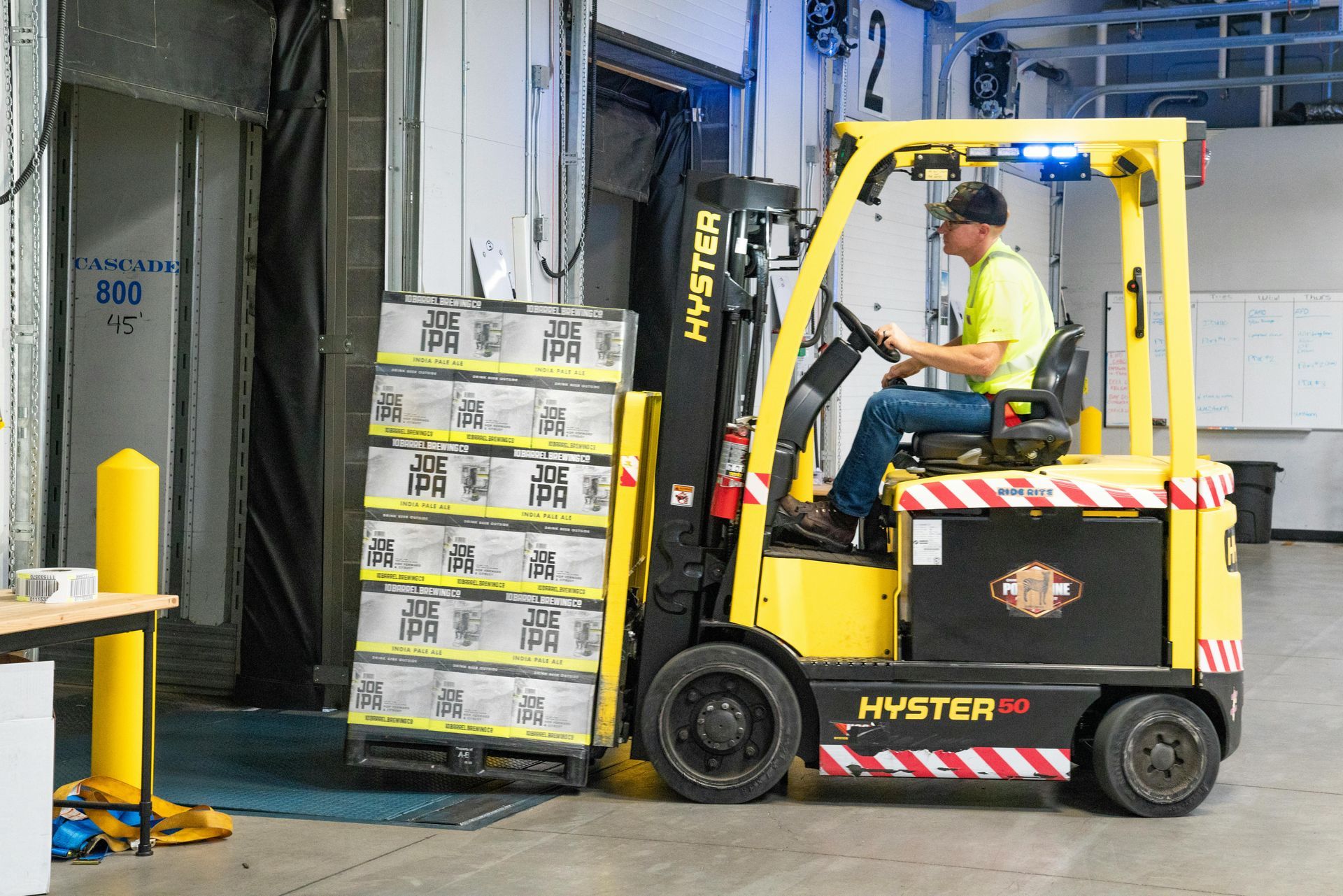 A factory worker learning how to operate new technology such as a forklift.