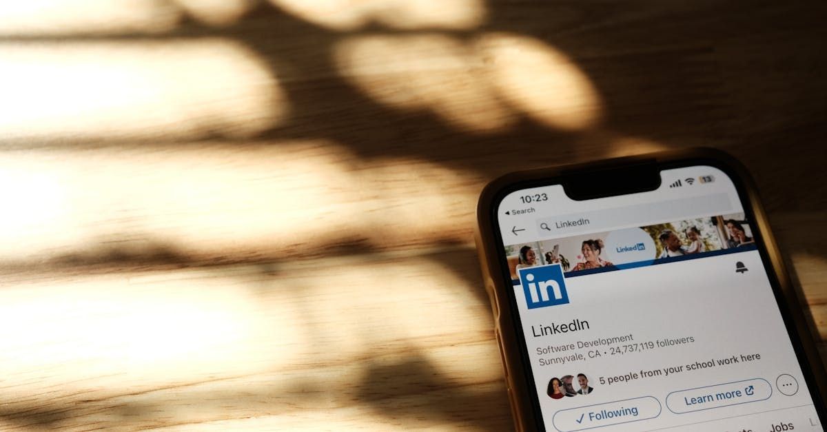 A factory worker looking at their LinkedIn profile on a mobile phone.