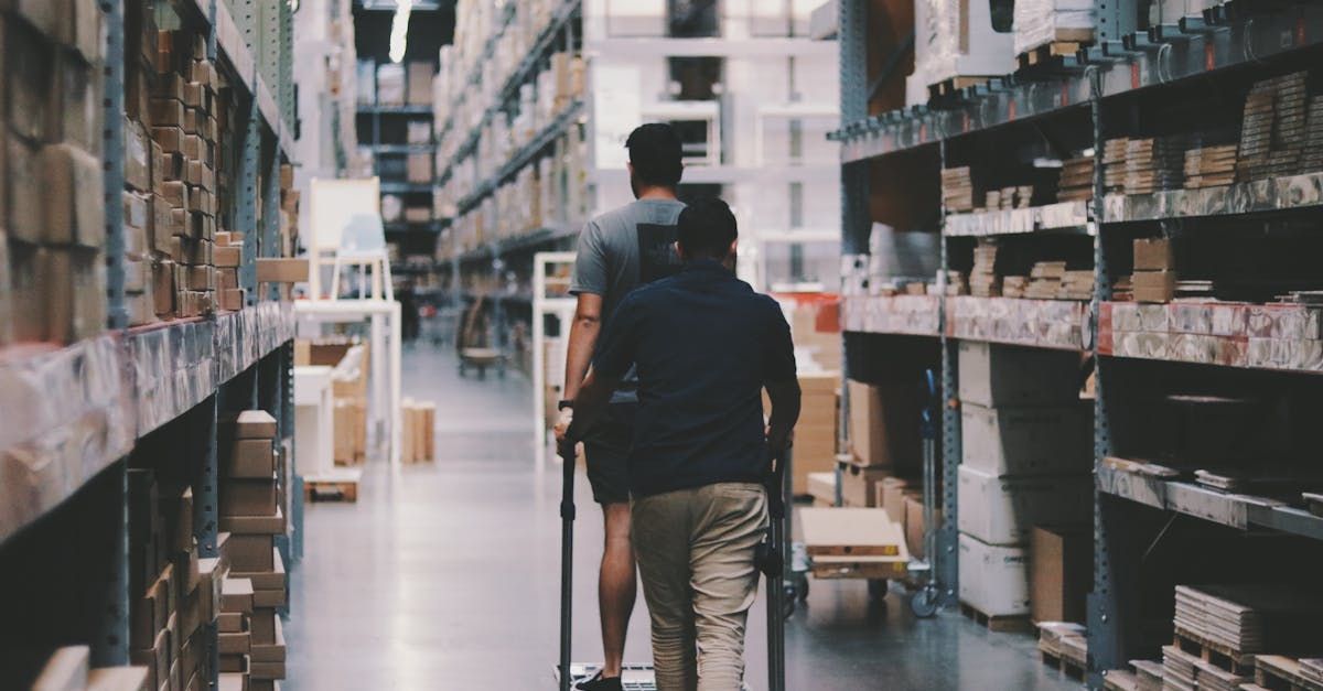 A temporary worker walking in a busy warehouse.