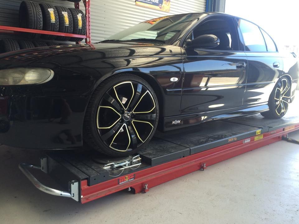 Black Car On A Lift — Tyre Master Albury In East Albury, NSW