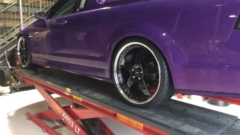 Purple Car On Top Of A Red Lift In The Garage — Tyre Master Albury In East Albury, NSW