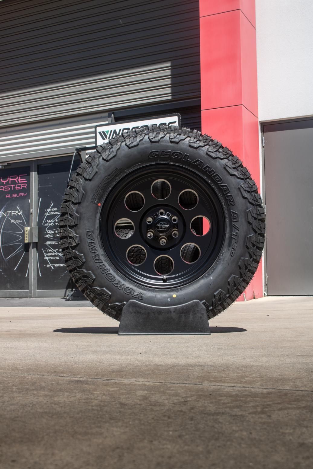 Black Yokohama Tyre On A Display Stand — Tyre Master Albury In East Albury, NSW