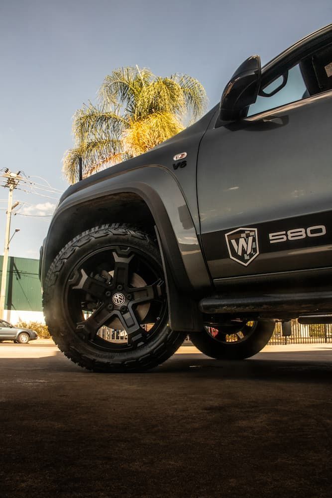 A Black Truck Is Parked On The Side Of The Road — Tyre Master Albury In Wodonga, VIC
