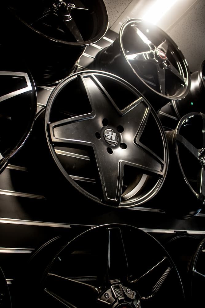 A Bunch Of Black Wheels Are Stacked On Top Of Each Other — Tyre Master Albury In Corowa, NSW