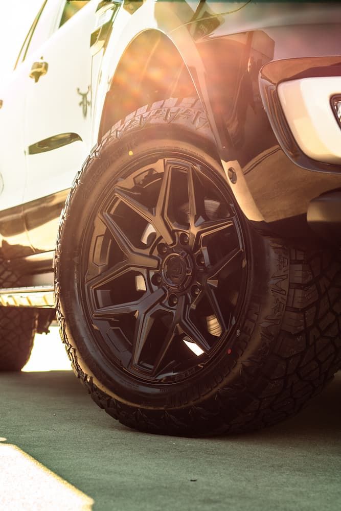 A White Truck With Black Wheels And Tires Is Parked In A Parking Lot — Tyre Master Albury In Corowa, NSW