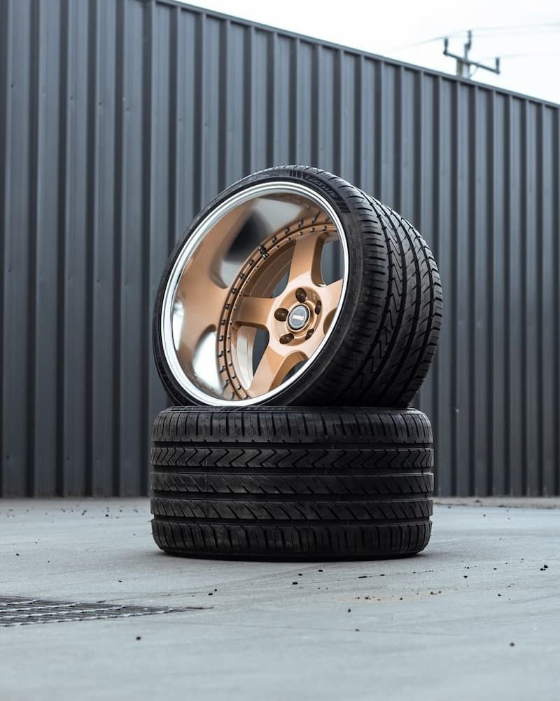 Two Tires Are Stacked On Top Of Each Other On A Concrete Surface — Tyre Master Albury In Wodonga, VIC