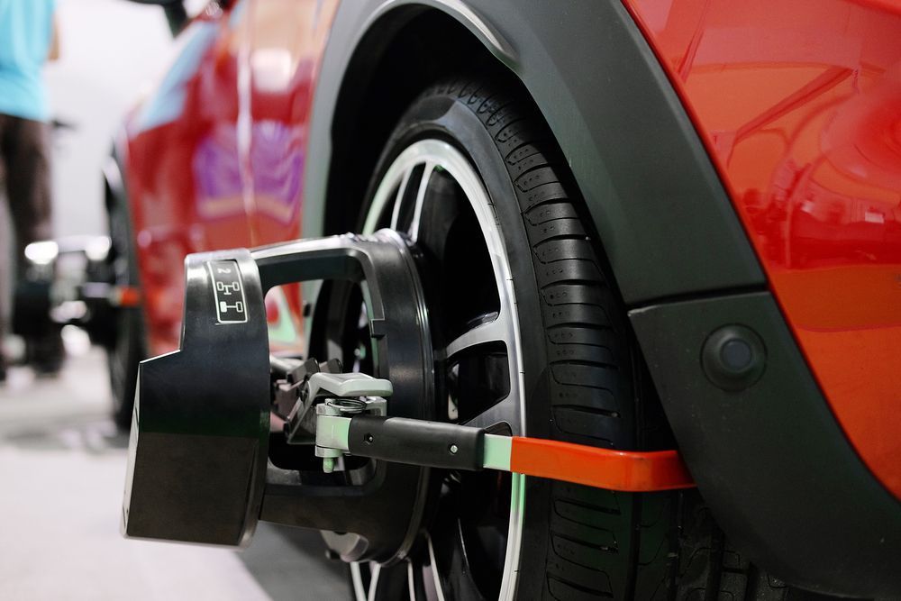 A Red Car Is Being Adjusted By A Machine — Tyre Master Albury In Wodonga, VIC