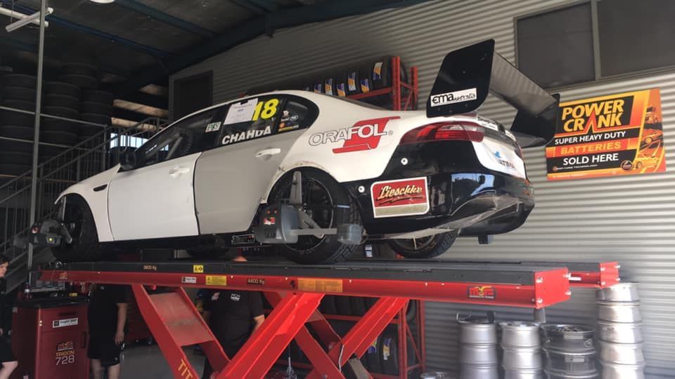White Car On A Lift In The Garage — Tyre Master Albury In East Albury, NSW