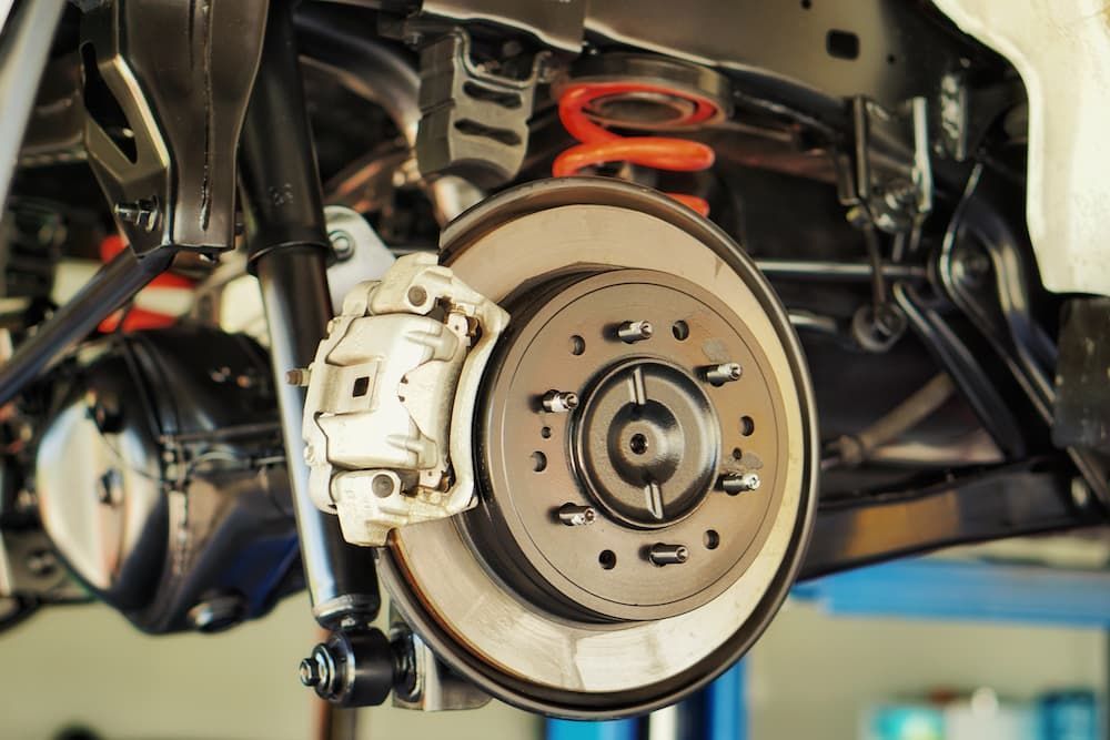 A Car Is Being Repaired On A Lift In A Garage — Tyre Master Albury In Wodonga, VIC