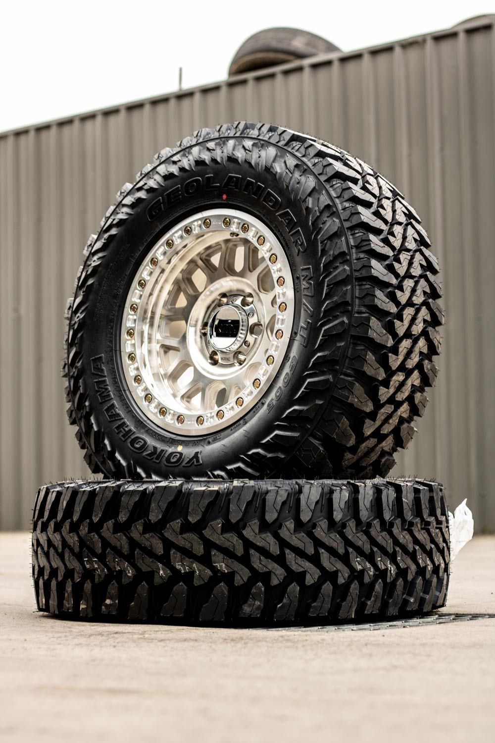 Image of a black tyre stacked on top of another tyre.