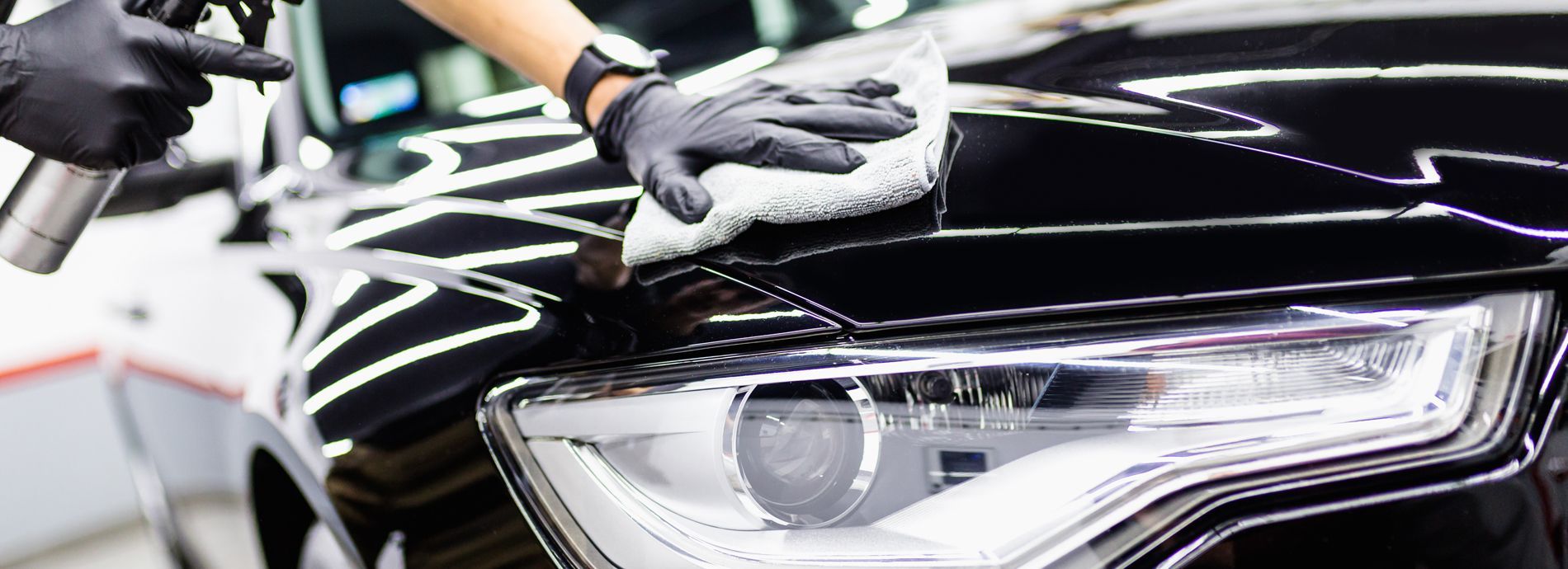 A person is polishing a car with a polisher.